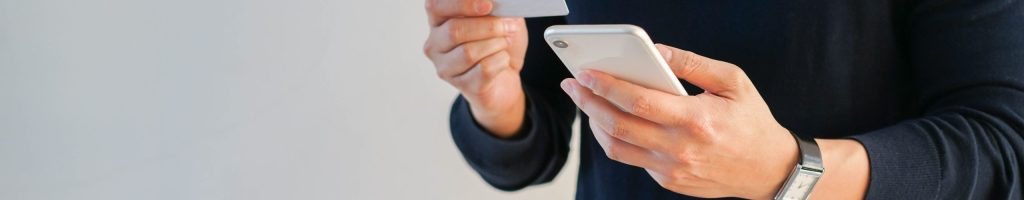 close up adult man holding smartphone  to choose or select items on marketplace website and paying order by using credit card for modern and comfortable lifestyle concept